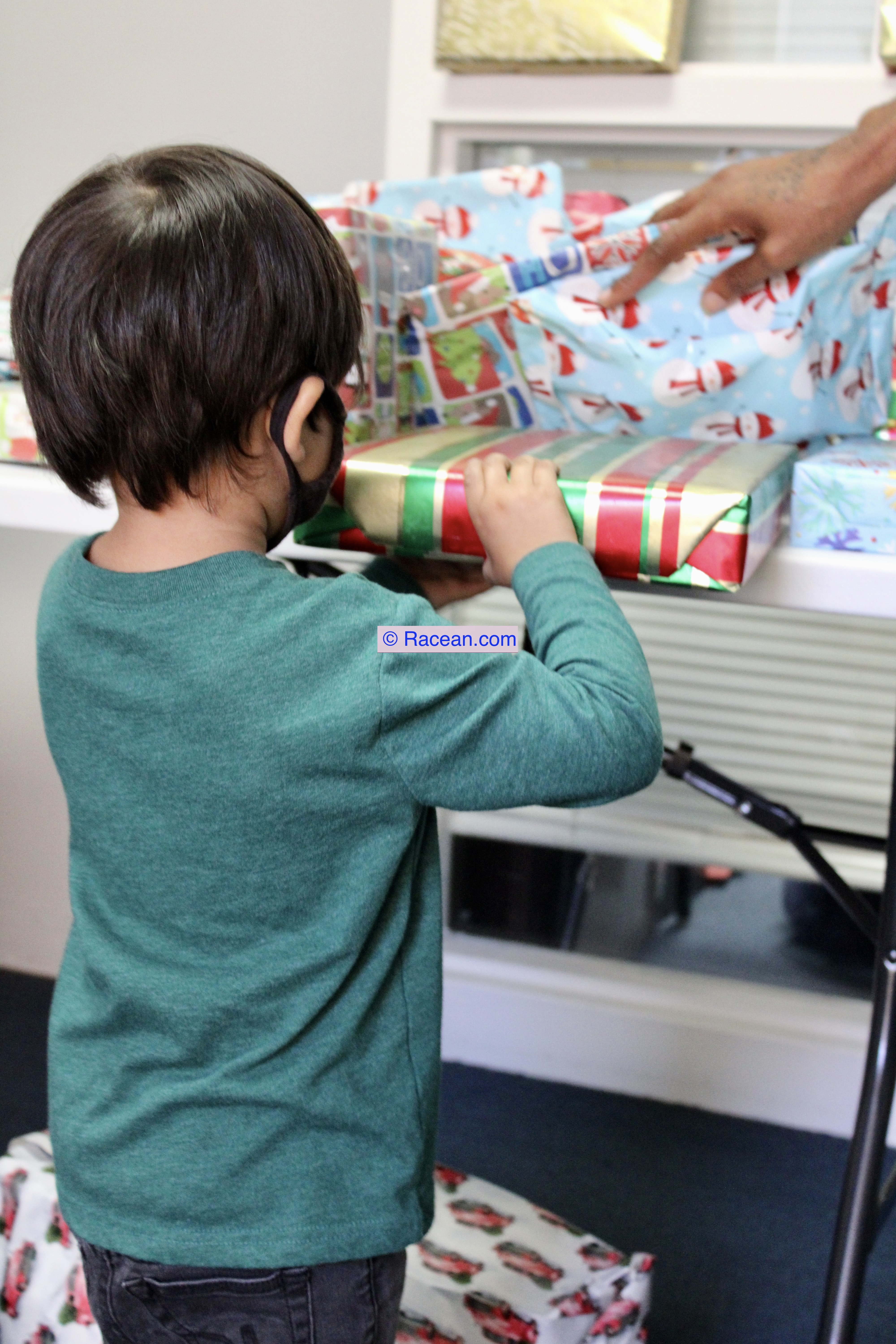 Toddler receiving a wrapped gift