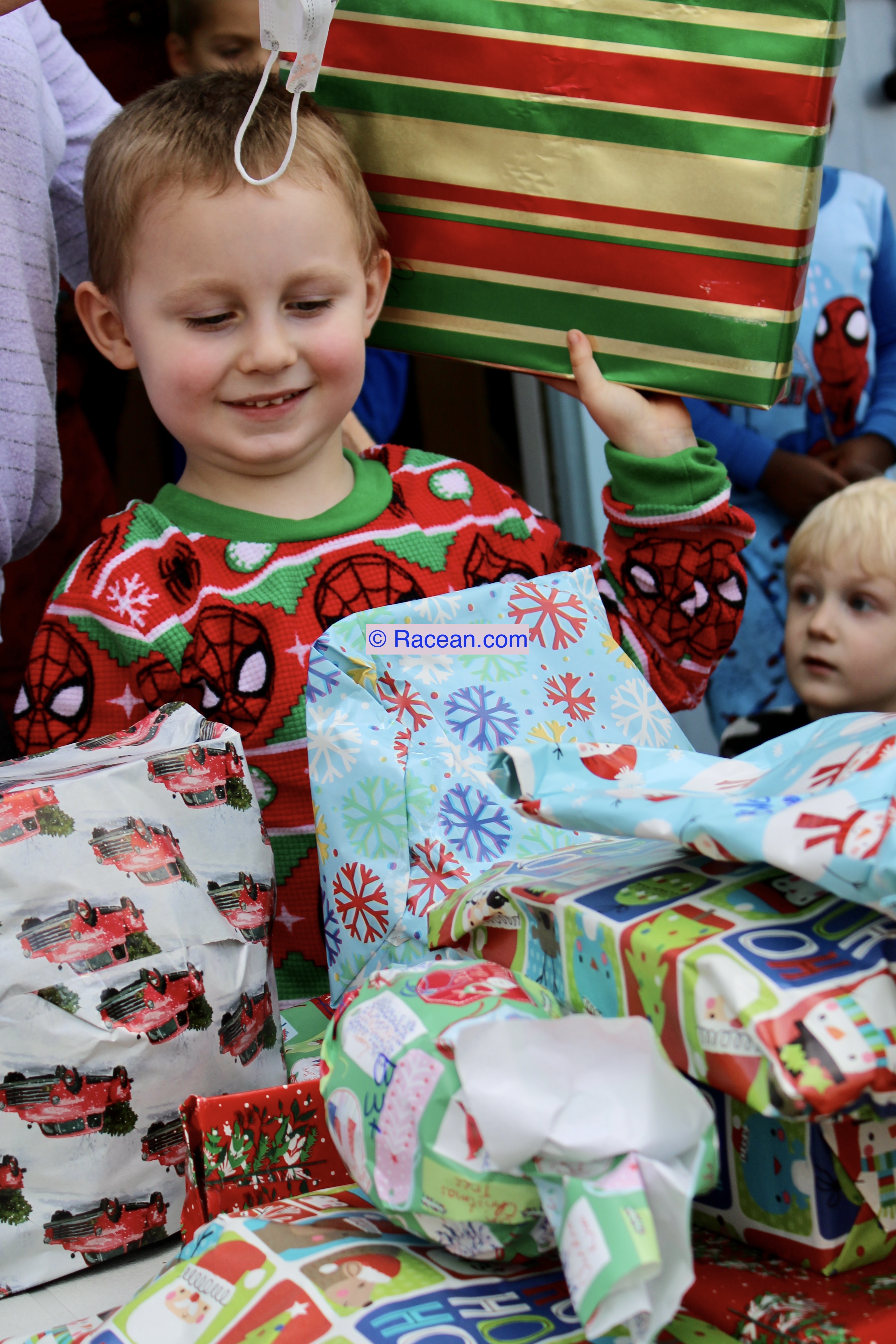 Child in Christmas pajamas with gifts
