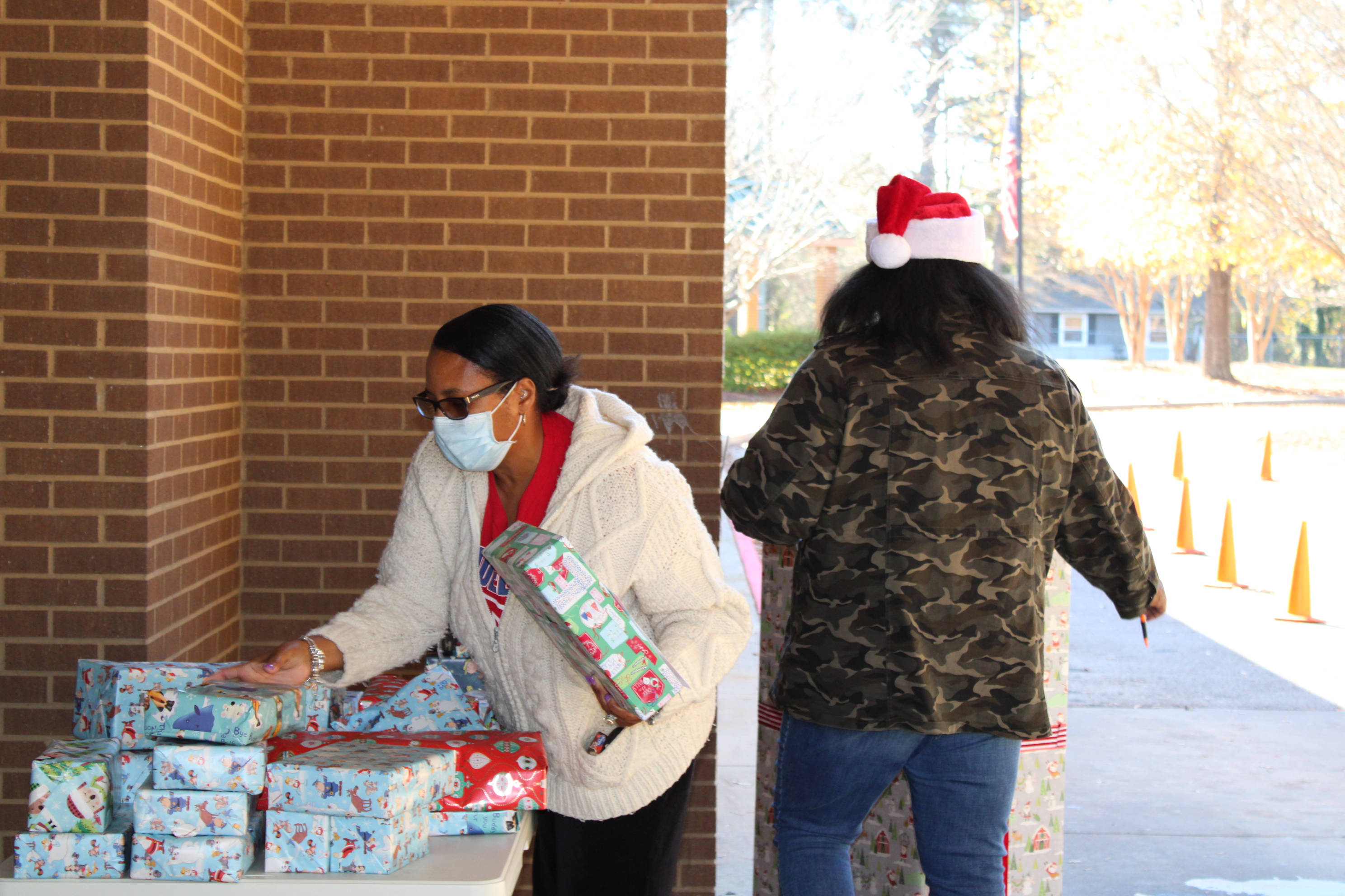 Volunteer with gifts at Heritage Academy